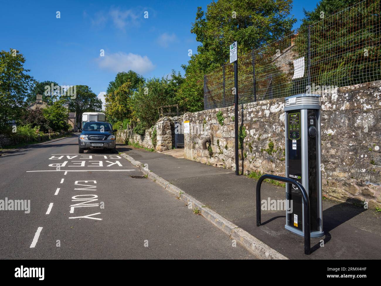 Electric vehicle charging station in a rural village in Northumberland Stock Photo