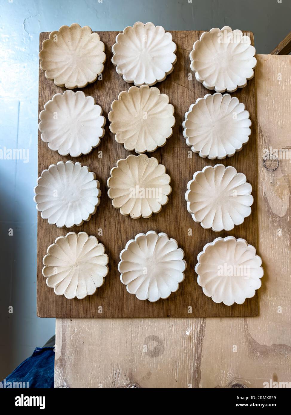 Ceramic plates and bowls drying before being bisque fired Stock Photo