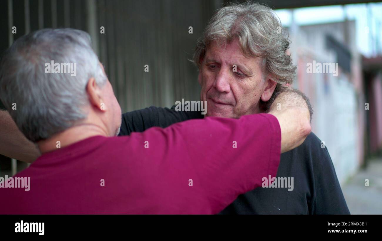 Heart-warming embrace between two senior friends in authentic loving ...
