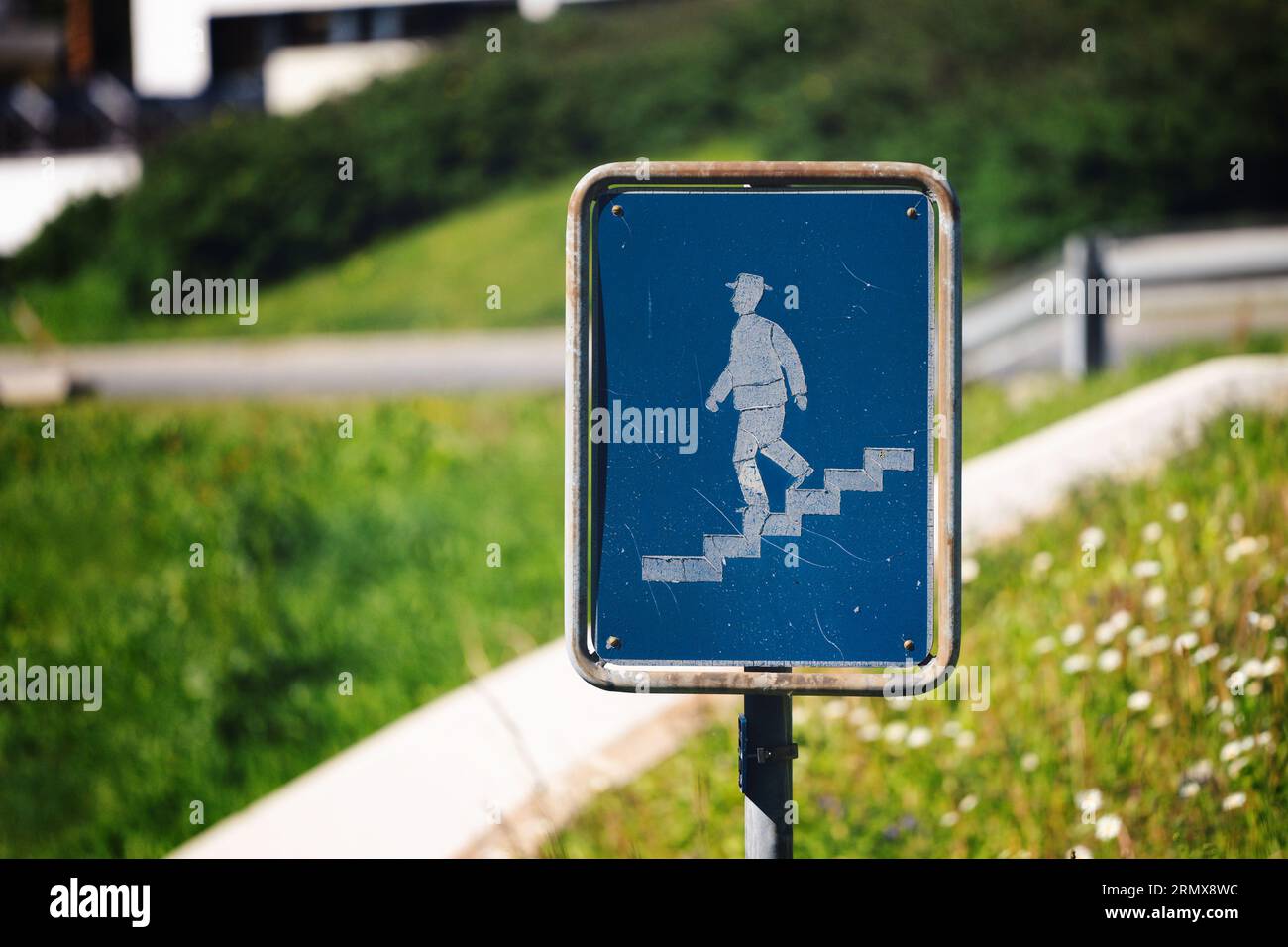 Traffic sign pedestrian descending, going down the stairs, crosswalk symbol Stock Photo