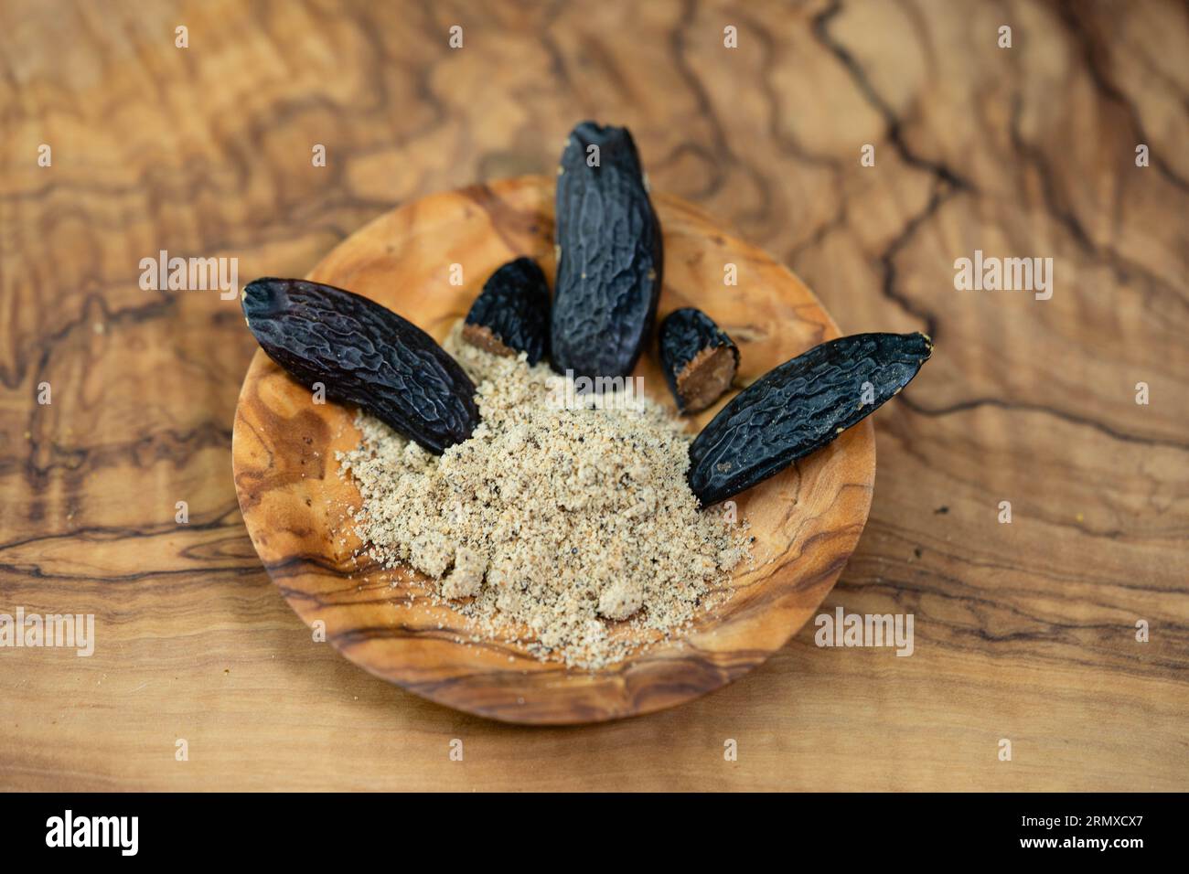brown dutch tonka bean on olive wood Stock Photo - Alamy