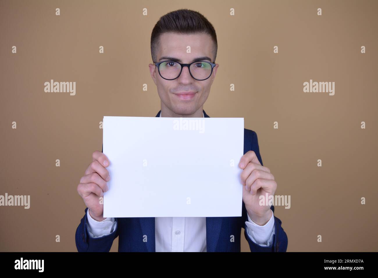 Smiling Young Handsome Elegant Man Holding White Paper on Copy Space on Isolated Background Stock Photo