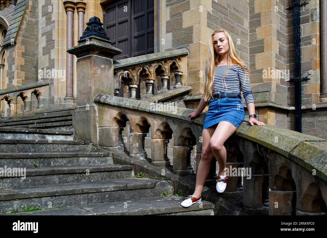 Rhianna Martin, a stunning blonde woman at Dundee's McManus art gallery and museum, enjoys the pleasant weather in Scotland, UK. Stock Photo