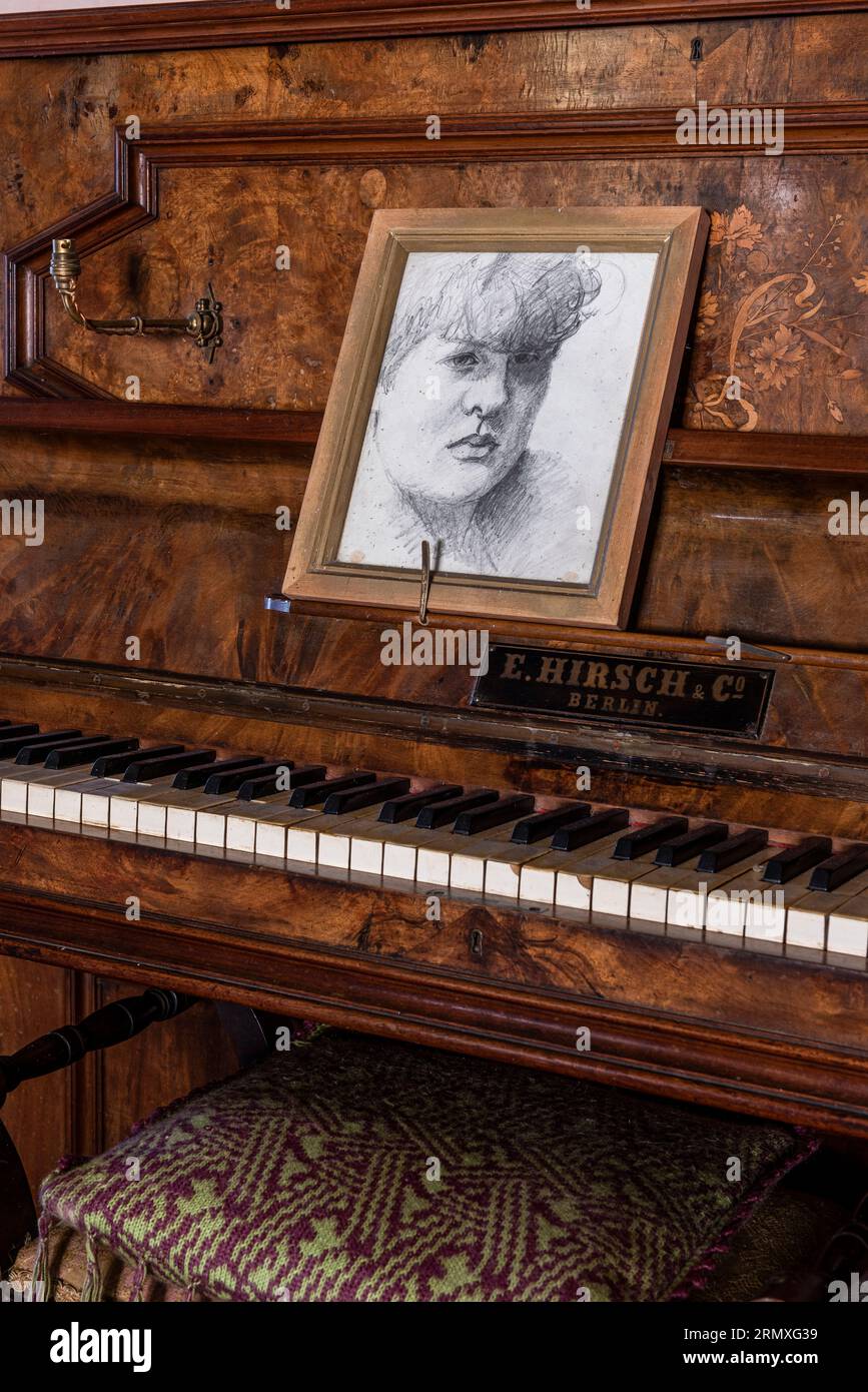 Artwork on music stand of piano in 18th century flower loft conversion near Penzance in Cornwall, UK Stock Photo