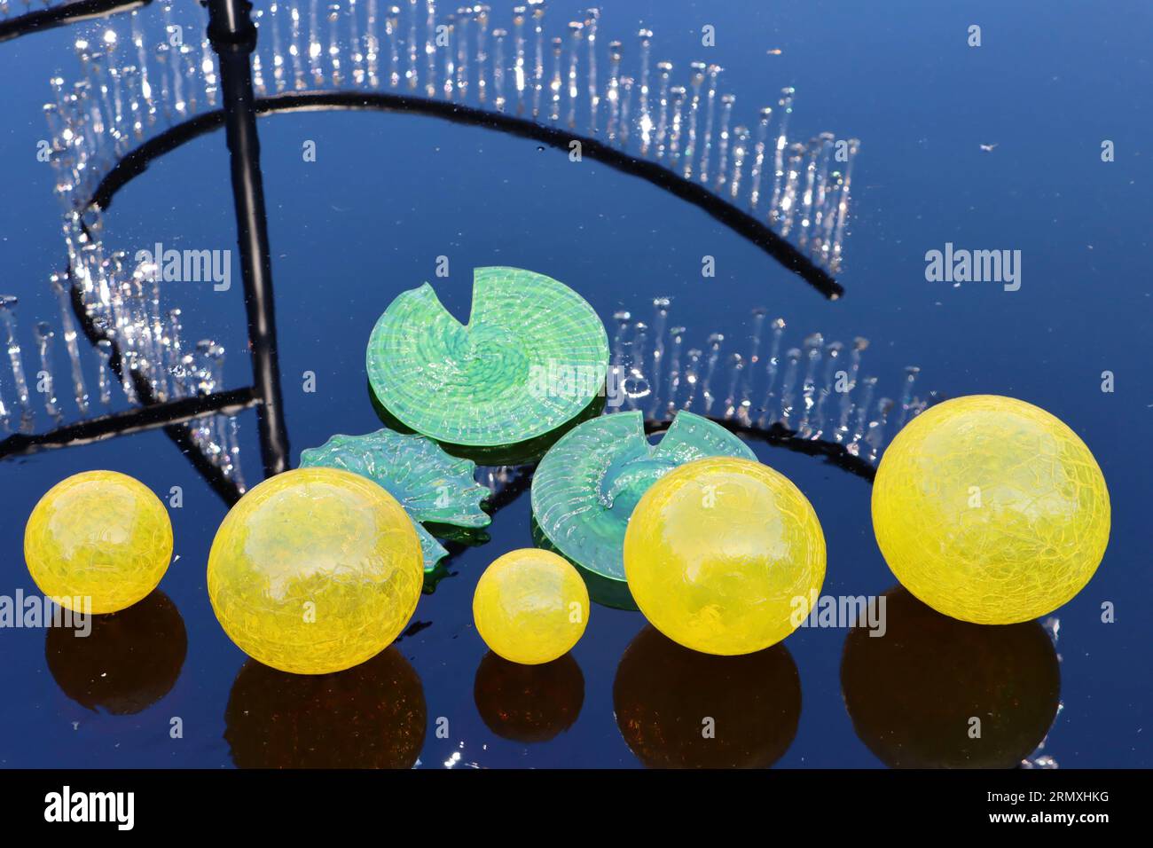 Large-scale glass-blown pieces by The Glass Asylum in the reflecting pool on Geis Terrace, Cleveland Botanical Garden, Cleveland, Ohio. Stock Photo