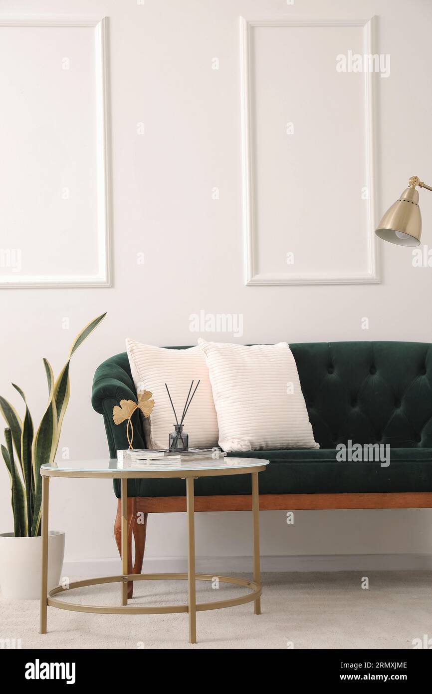 Interior of living room with green sofa and table Stock Photo - Alamy