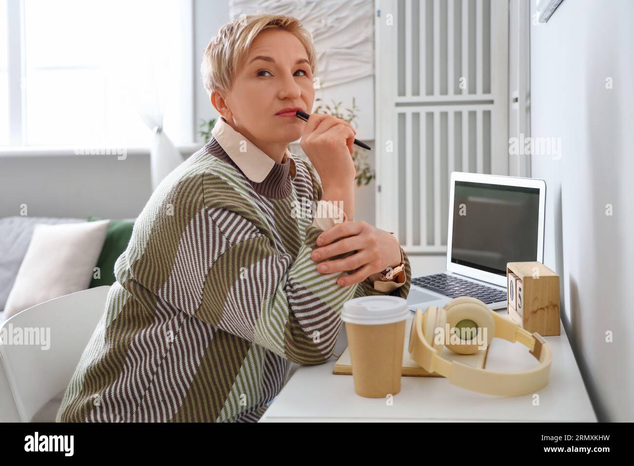Thoughtful mature woman sitting hi-res stock photography and images - Alamy