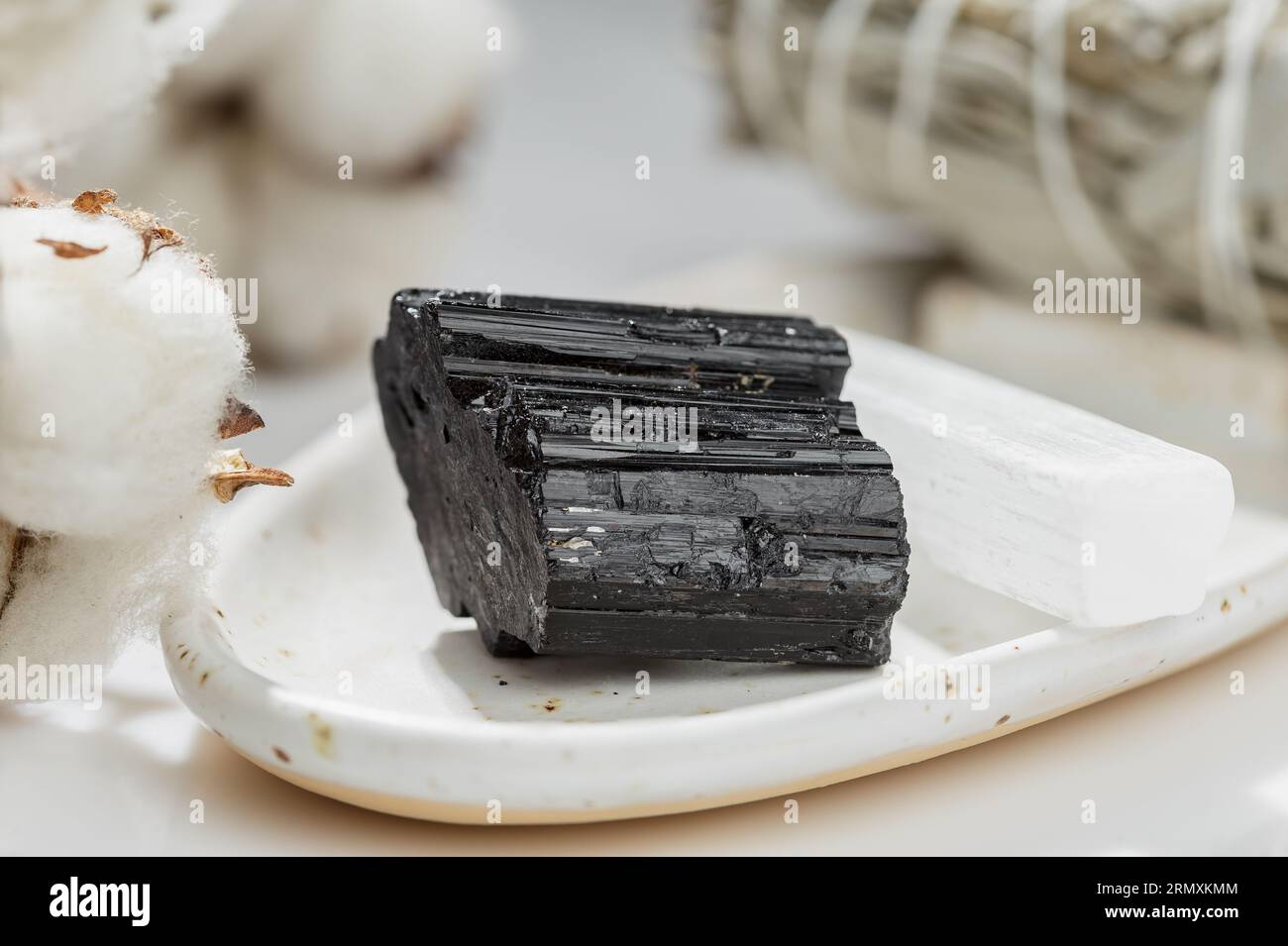 Natural Uncut Black Tourmaline Crystal on the White Ceramic Tray Stock Photo