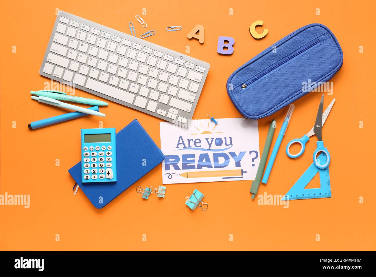 Card with question ARE YOU READY?, stationery and keyboard on orange background Stock Photo
