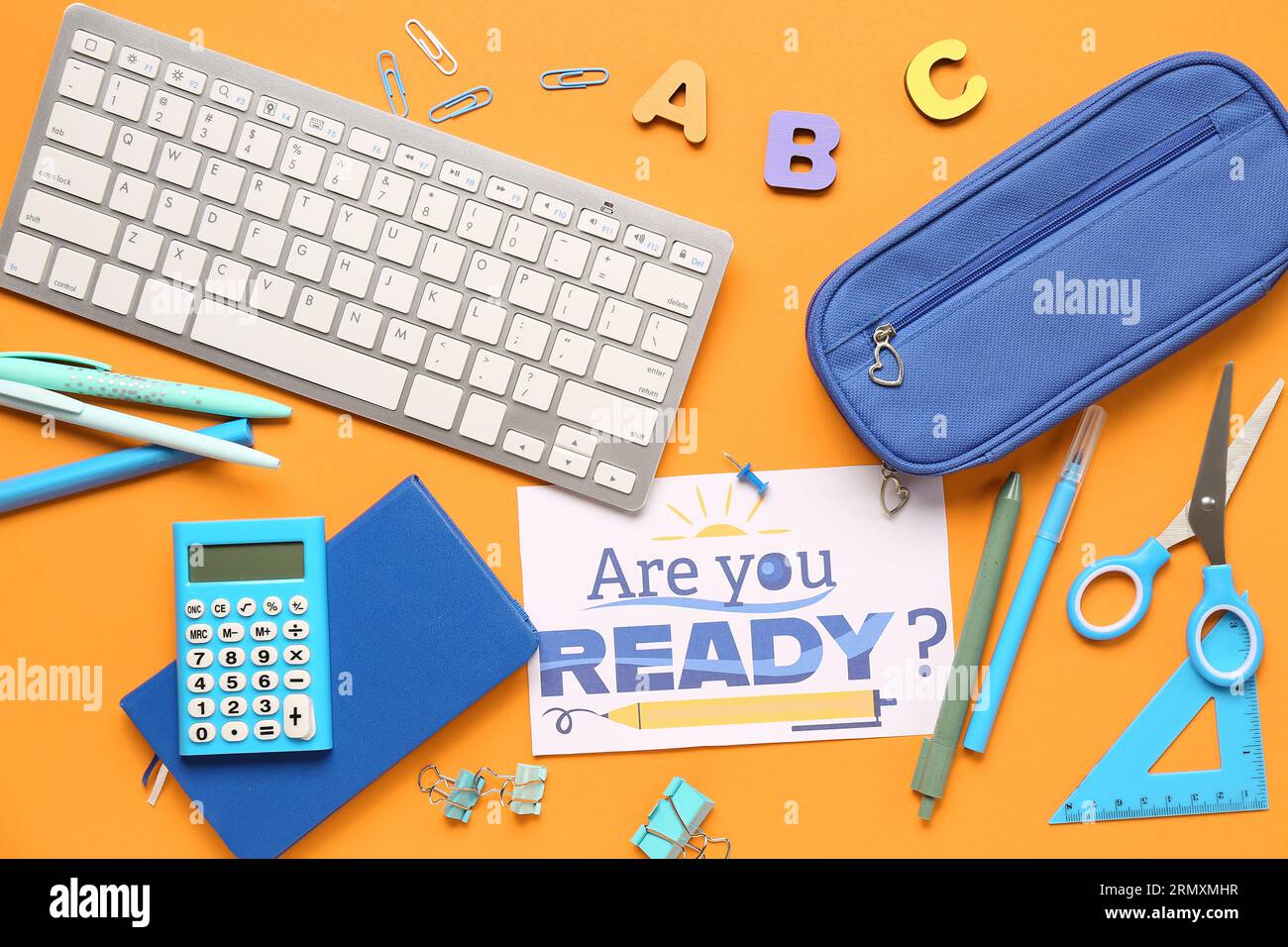 Card with question ARE YOU READY?, stationery and keyboard on orange background Stock Photo