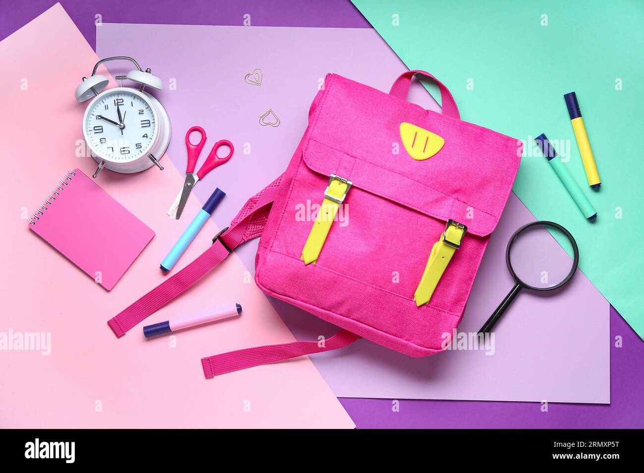Stylish school backpack with different stationery on color background Stock Photo