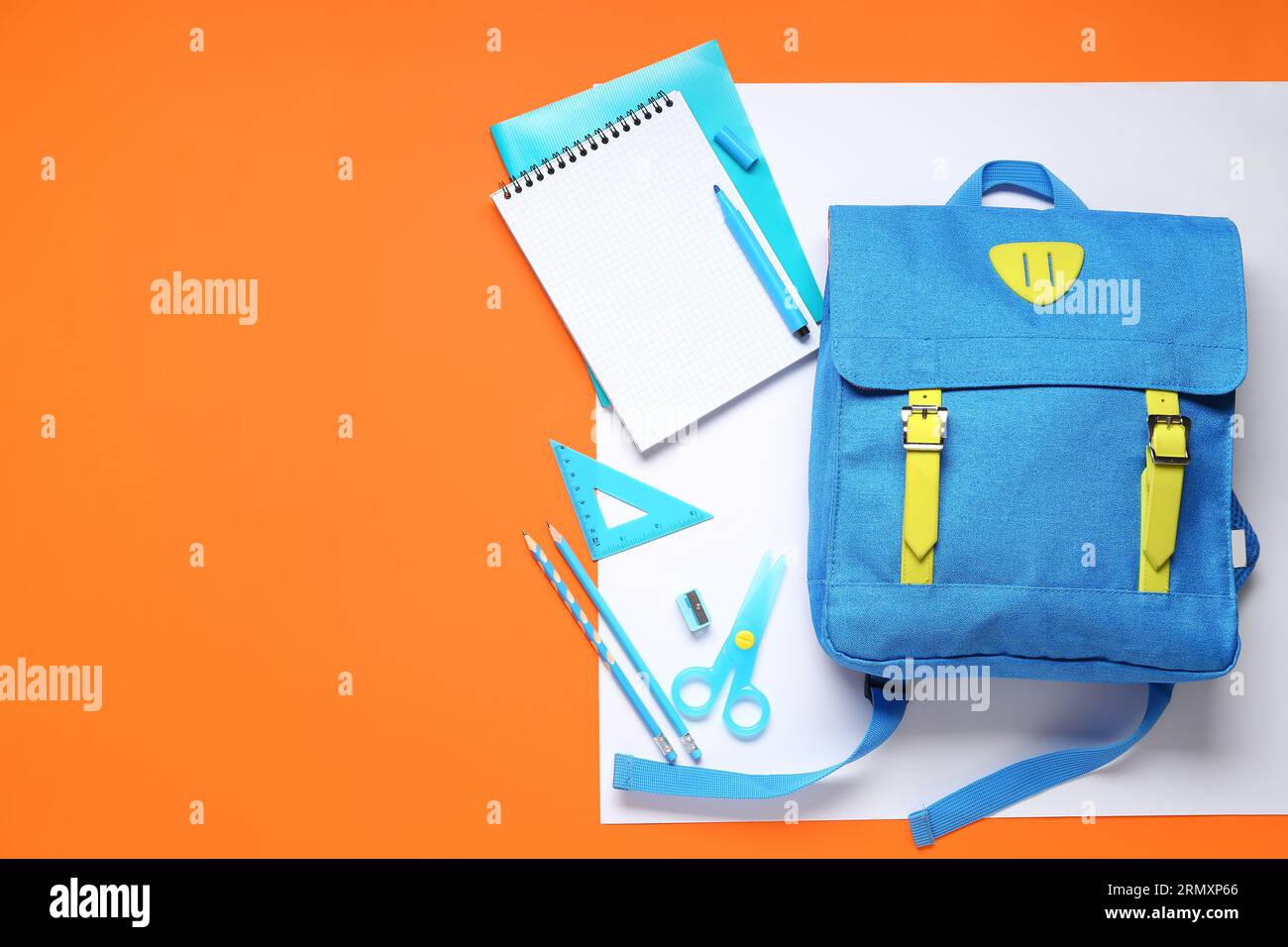 Stylish school backpack with different stationery on color background Stock Photo