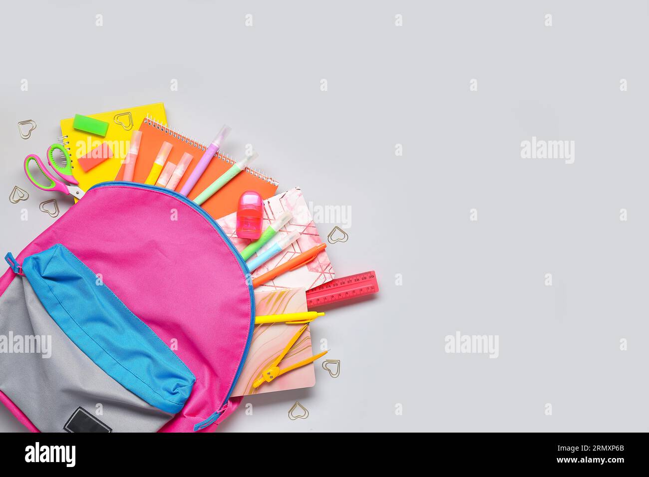 Stylish school backpack with different stationery on grey background Stock Photo