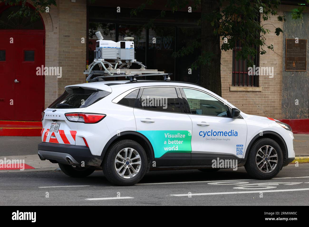 A CycloMedia Ford Escape data capture vehicle equipped with LiDAR, GPS, and 360 panoramic camera systems, on a New York City street. Stock Photo