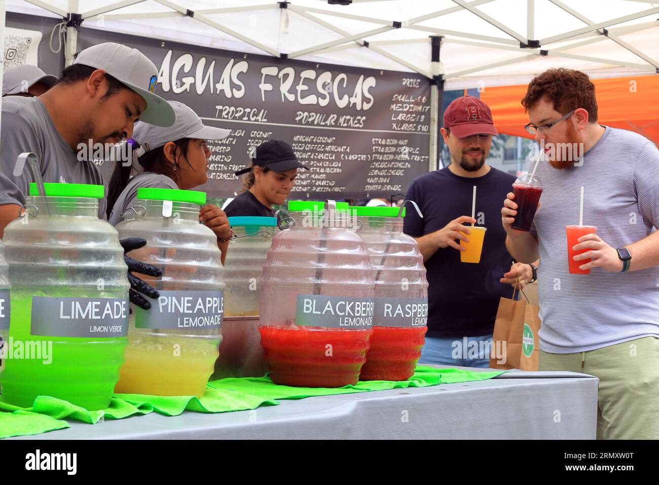 Food vendor selling Aguas Frescas tropical juice drinks at a food festival street fair on Broadway in New York City, 26 August 2023. Stock Photo