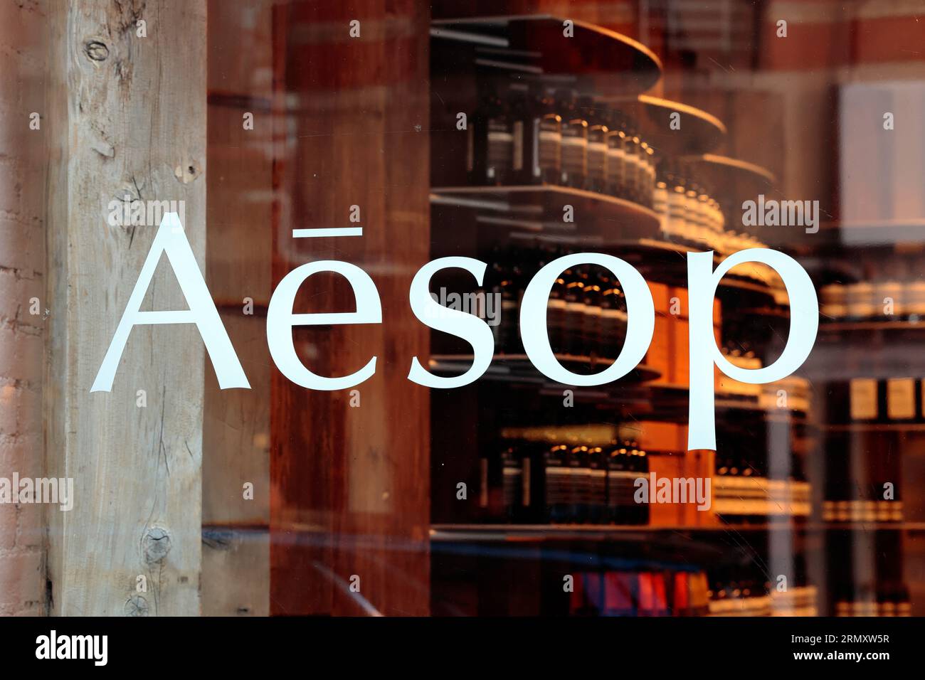 Window signage for Aesop skin and body care at a retail store. Stock Photo