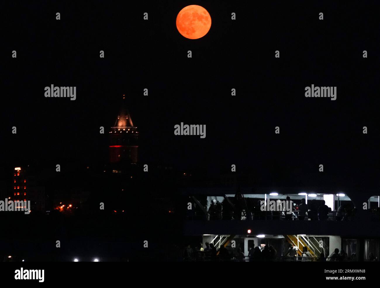 The full moon rises behind the Galata tower in Istanbul, Turkey ...