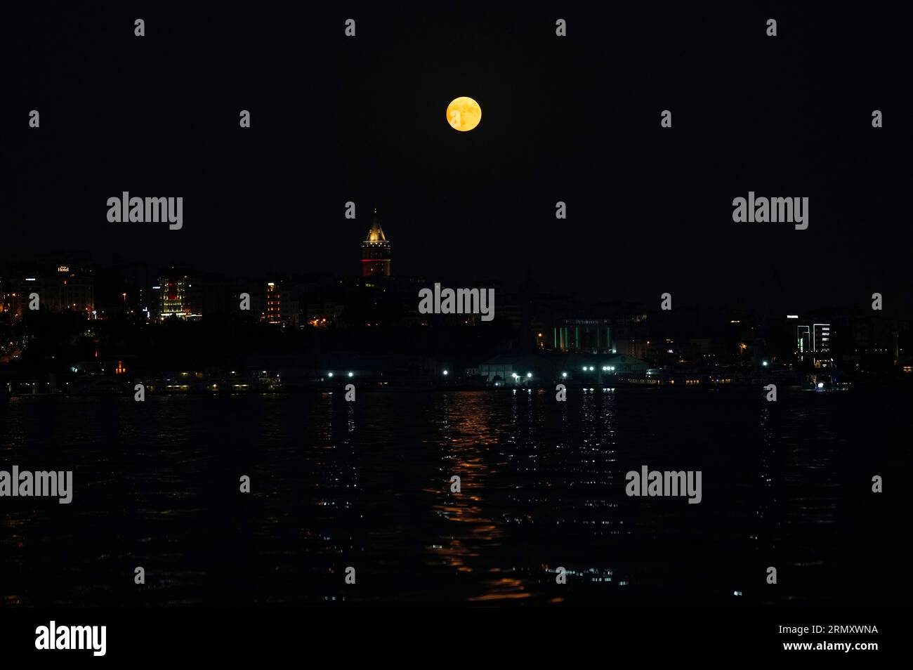 The full moon rises behind the Galata tower in Istanbul, Turkey ...