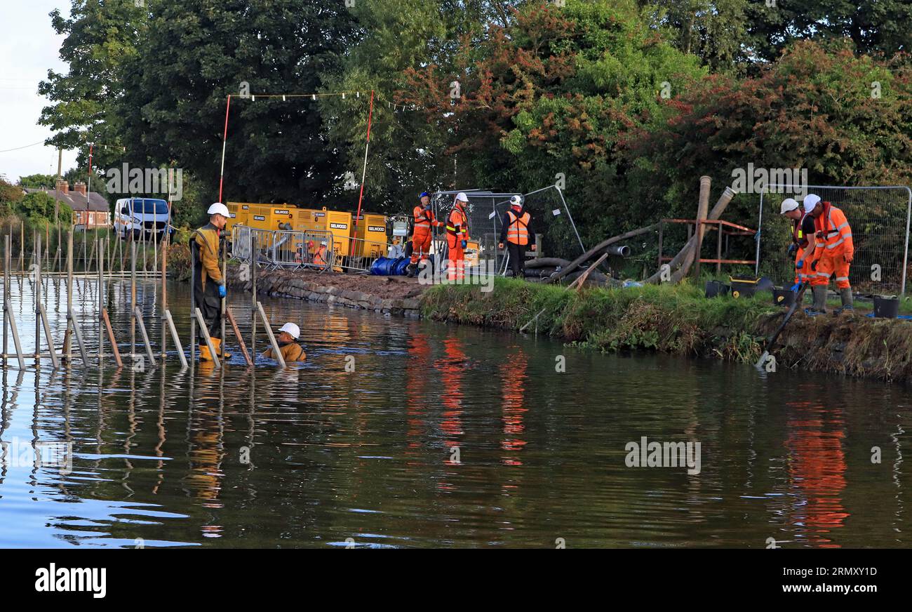 Contractors are removing the scaffolding that supported the fibre dams for repair to the damaged wash wall of the Leeds and Liverpool near Burscough Stock Photo