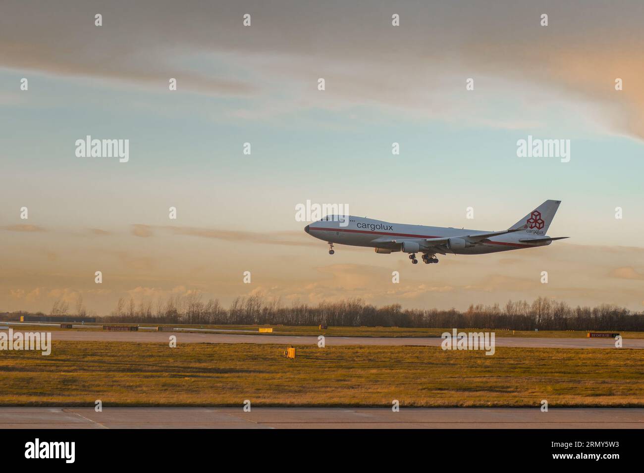 GLASGOW, UK, 24.3.2023: Cargolux 747 freighter jet is landing on glasgow airport in early morning with beautiful strong backlight Stock Photo