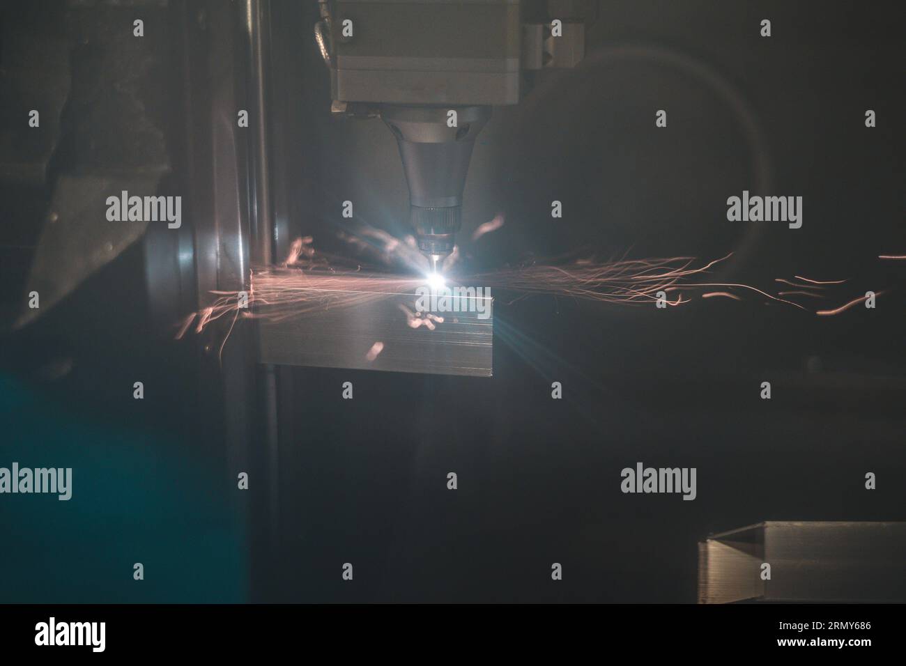 side view of laser plasma cutter in operation when cutting and drilling