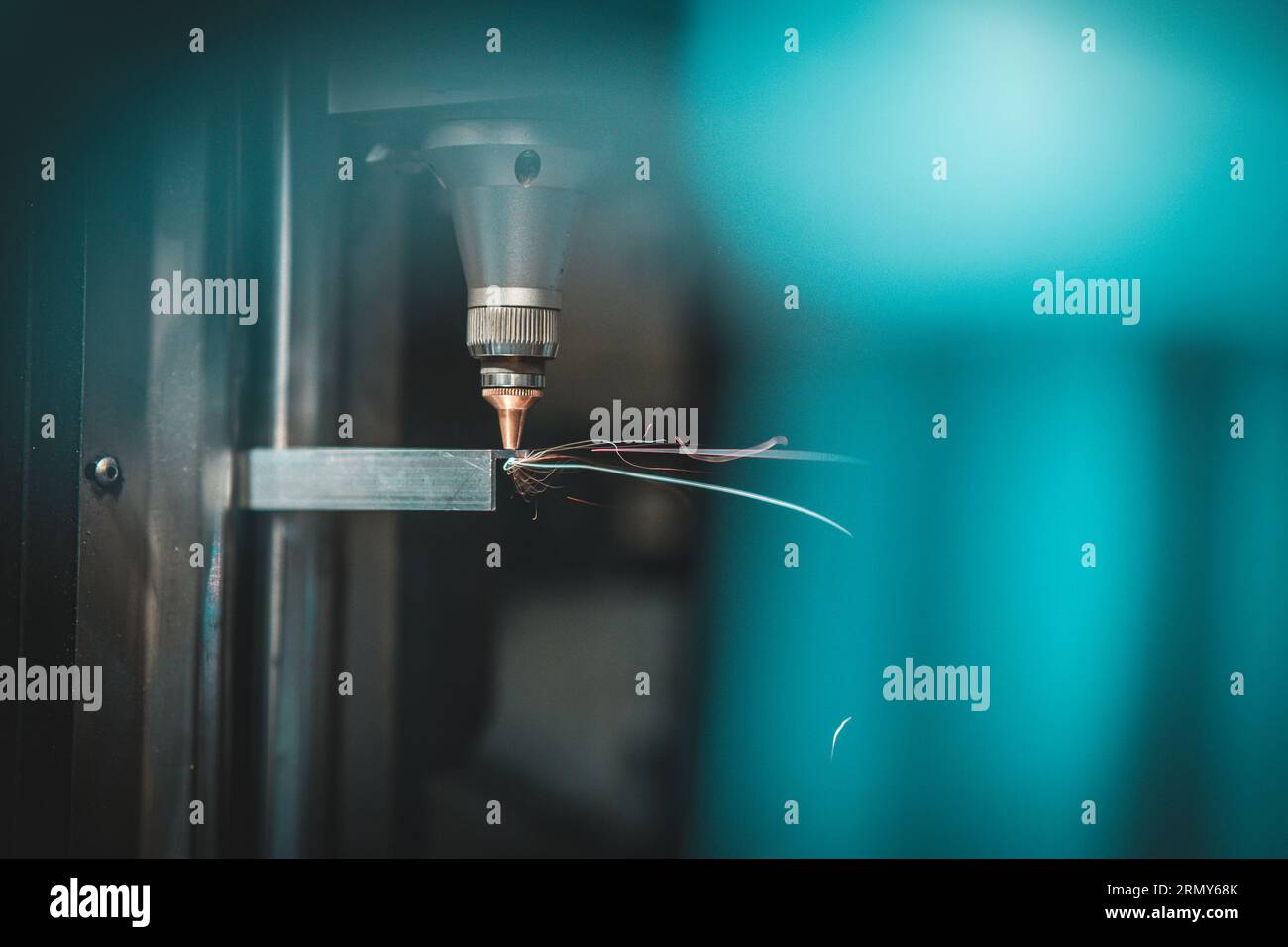 Detail of laser plasma cutter in operation when cutting and drilling holes in an aluminium