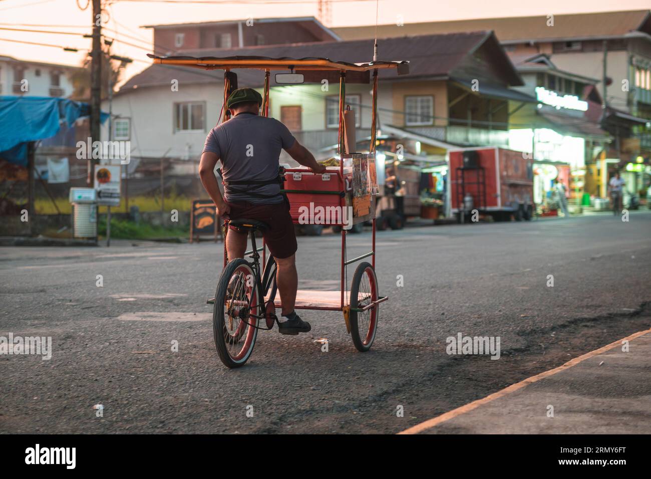 Unknown street vendor on a trycycle rolling on the main street of Bocas Del Toro island village, touristic spot in the panama part of caribbean. Stock Photo