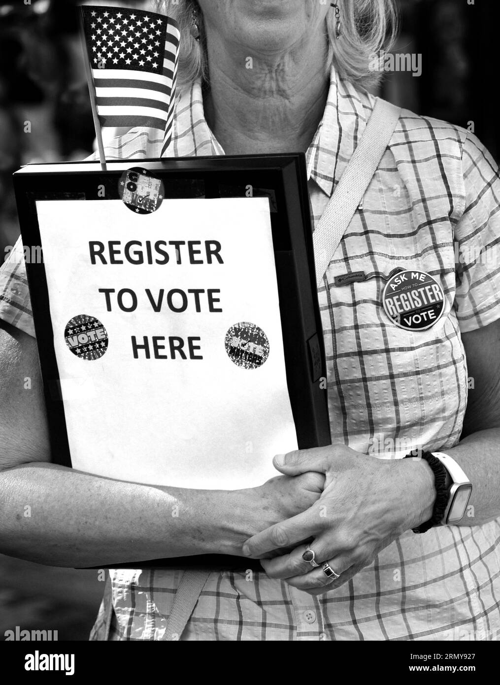 A volunteer offers an opportunity for residents and visitors to register to vote in Santa Fe, New Mexico. Stock Photo