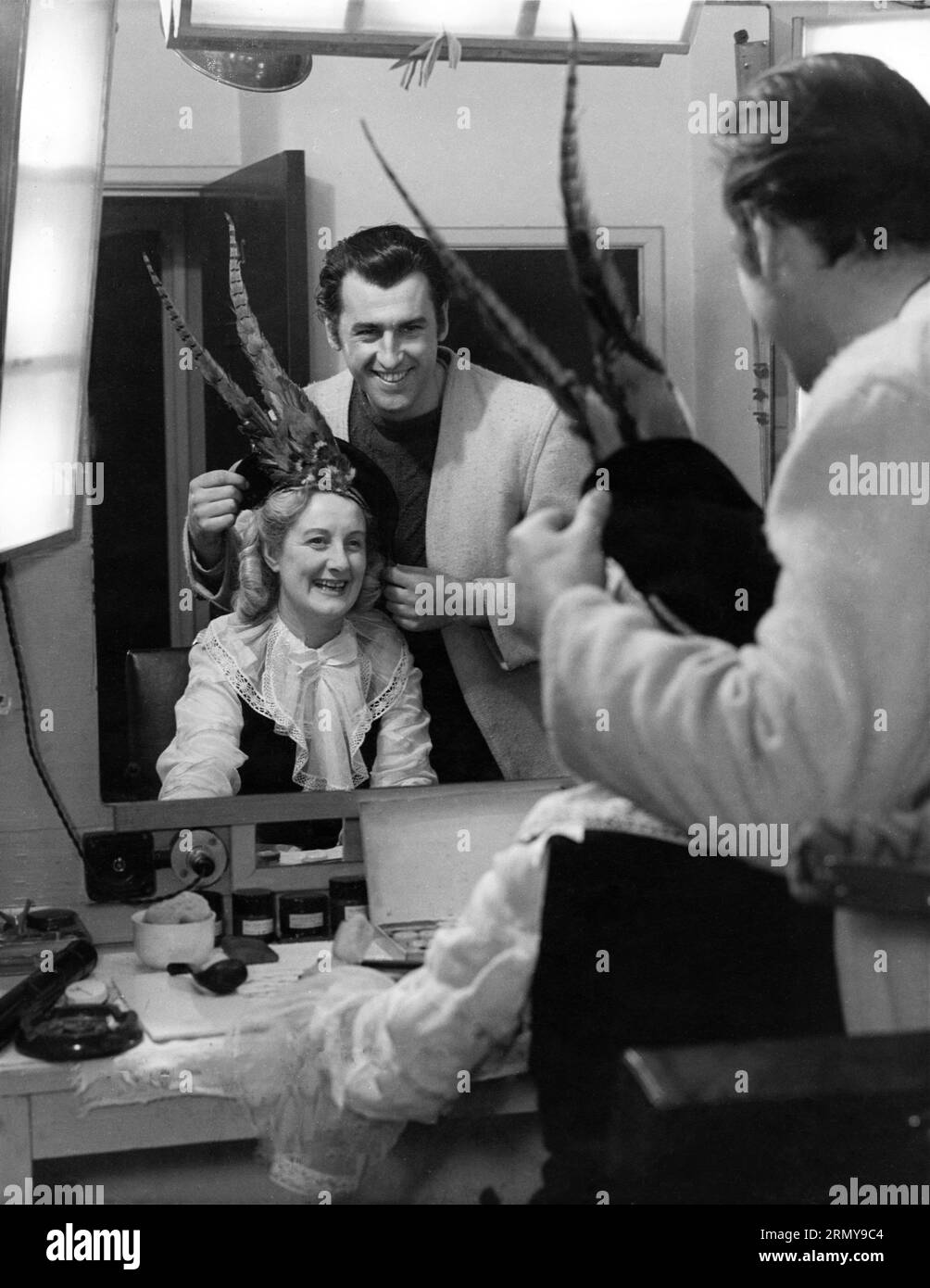 STEWART GRANGER in costume for his latest film CAPTAIN BOYCOTT 1947 dressing room candid with WILKIE, leading lady in CINDERELLA pantomime likely held at film studio publicity for Individual Pictures Stock Photo