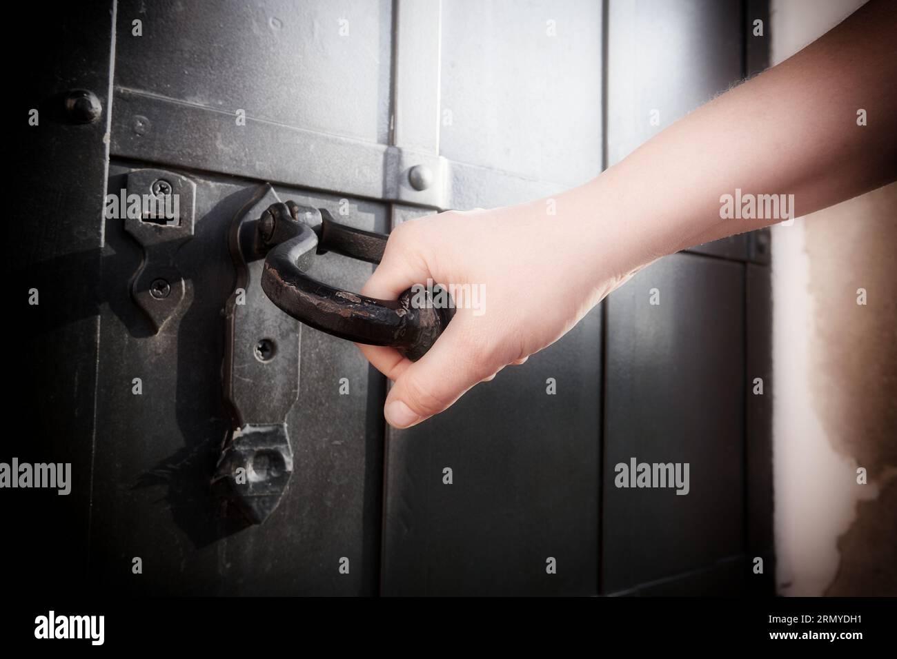 Close up of a woman's hand holding the handle of a door. Soft filter on the image Stock Photo