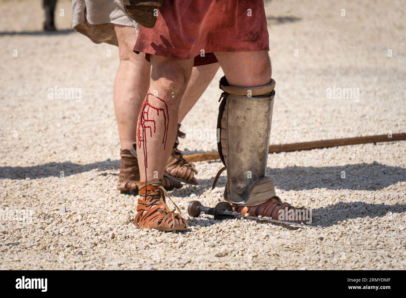 A defeated gladiator with bleeding feet Stock Photo