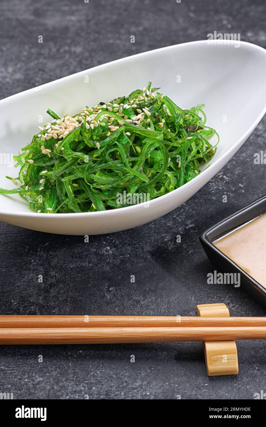sushi rolls with wasabi and ginger with chopsticks Stock Photo