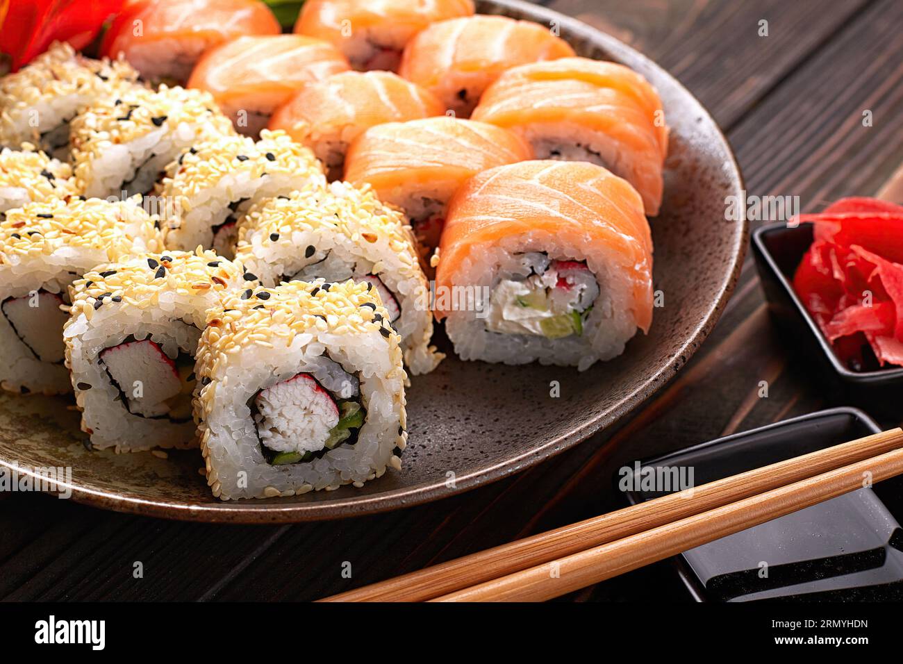 sushi rolls with wasabi and ginger with chopsticks Stock Photo