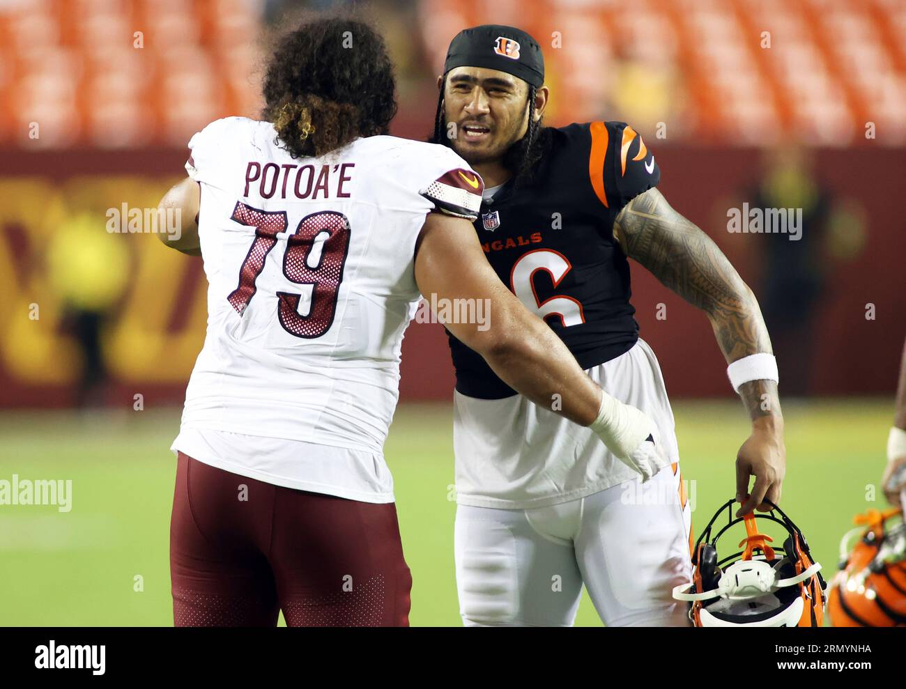 Washington Commanders defensive tackle Benning Potoa'e (79) and Cincinnati  Bengals tight end Devin Asiasi (86) both greet each other after an NFL  preseason football game, Saturday, August 26, 2023 in Landover. (AP