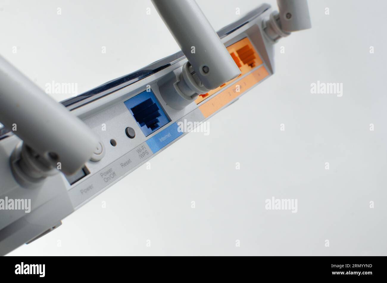 Close-up detail of a modern Wi-Fi router, with multiple inputs and ...