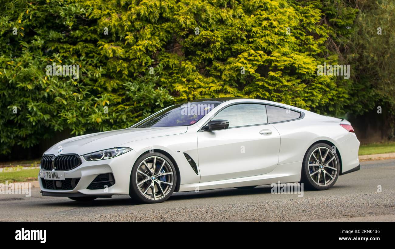 Whittlebury,Northants,UK -Aug 27th 2023: 2020 white Bmw 8 series M859   car travelling on an English country road Stock Photo