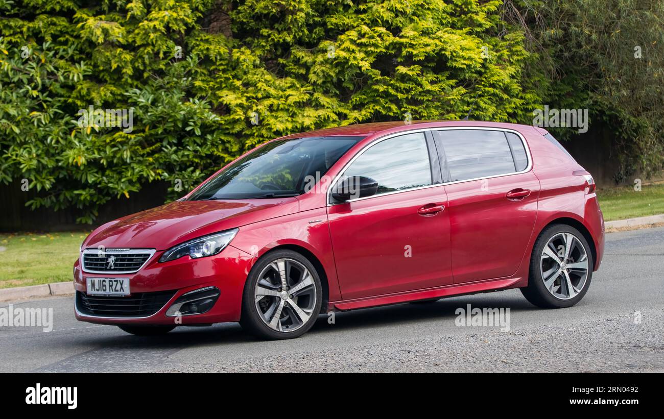 Whittlebury,Northants,UK -Aug 27th 2023:  2016 red Peugeot 308 estate  car travelling on an English country road Stock Photo