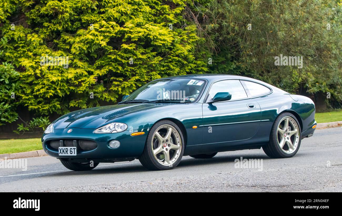 Whittlebury,Northants,UK -Aug 27th 2023:  2001 green Jaguar XKR  car travelling on an English country road Stock Photo