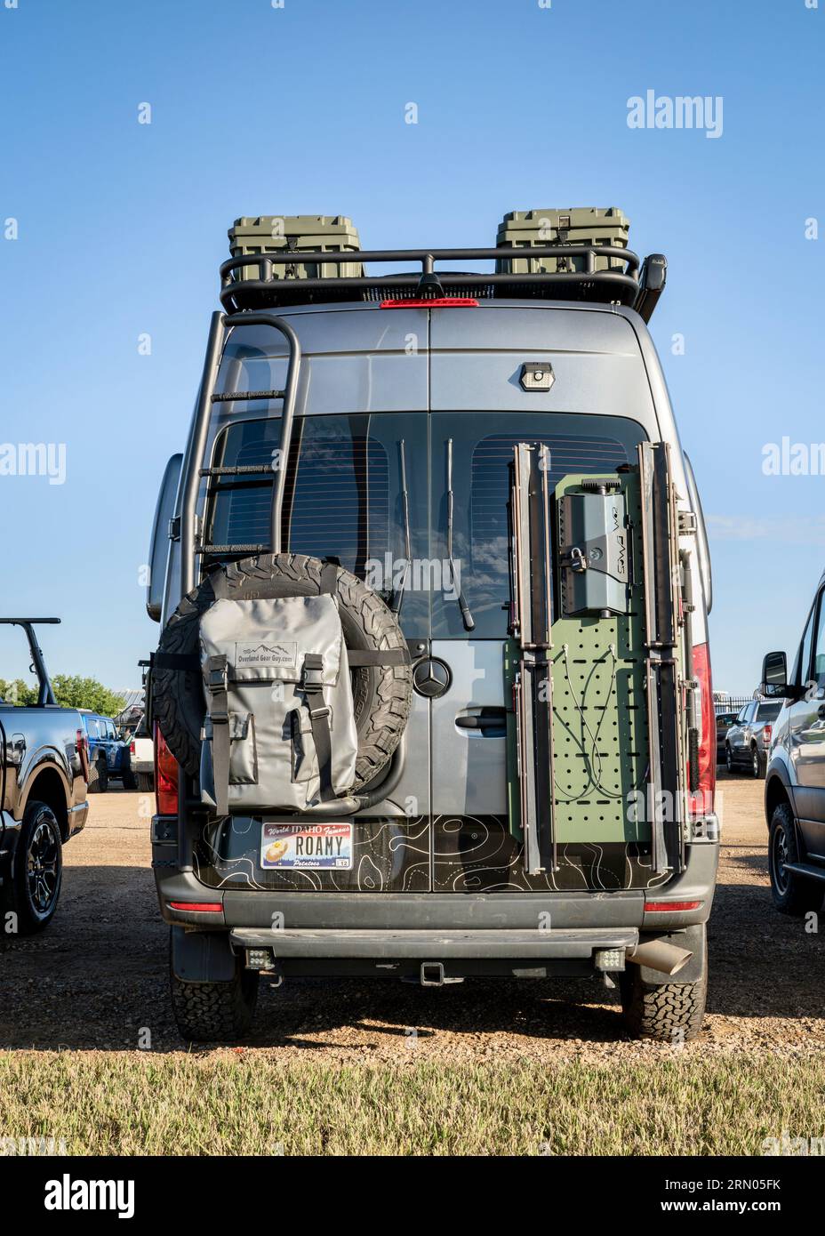 Loveland, CO, USA - August 27, 2023: Back of Mercedes Sprinter 4x4 camper van with a spare tire, roof ladder and rack with different gear attached. Stock Photo