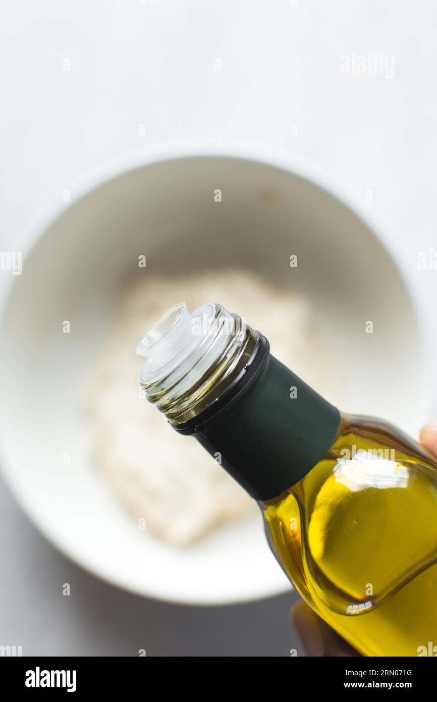 Pouring olive oil into a measuring spoon, measuring a tablespoon of oil Stock Photo Alamy