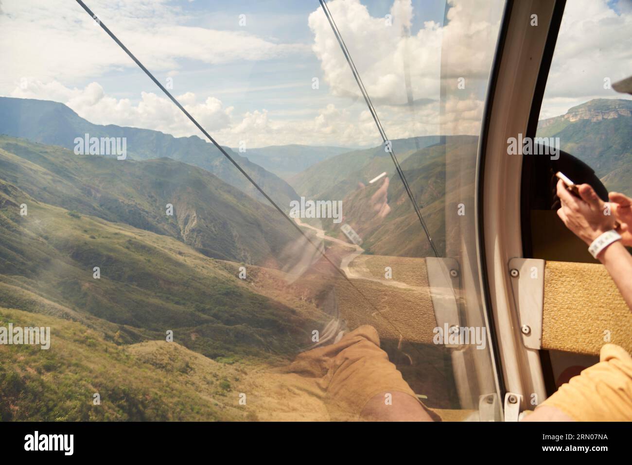 Unrecognizable person inside a cable car cabin in the Chicamocha Canyon, in Santander, Colombia. Stock Photo