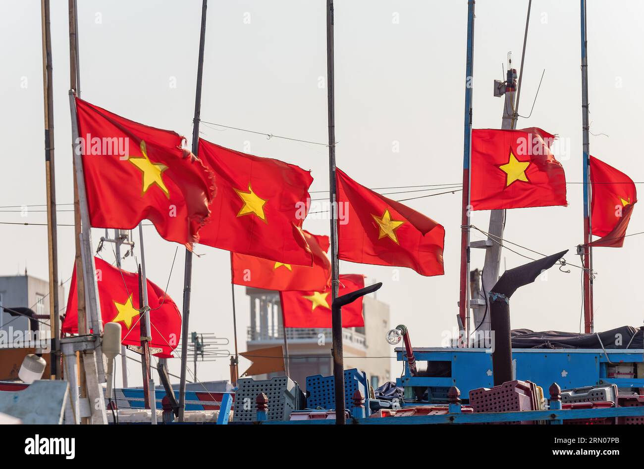 Vietnamese flags on fishing boats at Hai Thanh, a village in Thanh Hoa Province of Vietnam. Stock Photo