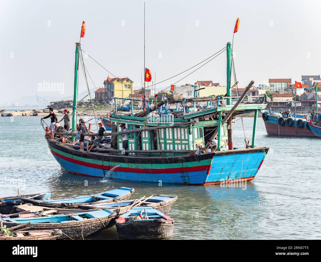 Young men onboard a fishing boat in Hai Thanh, a village in the Thanh Hoa province of Vietnam. Stock Photo