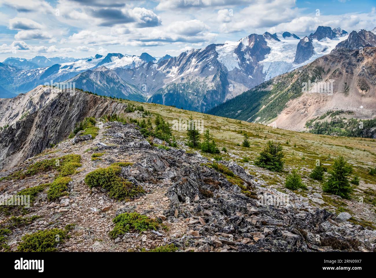 A rocky ridge in Bugaboo Provincial Park, BC overlooking Bugaboo Spire, glaciers, and other nearby peaks Stock Photo