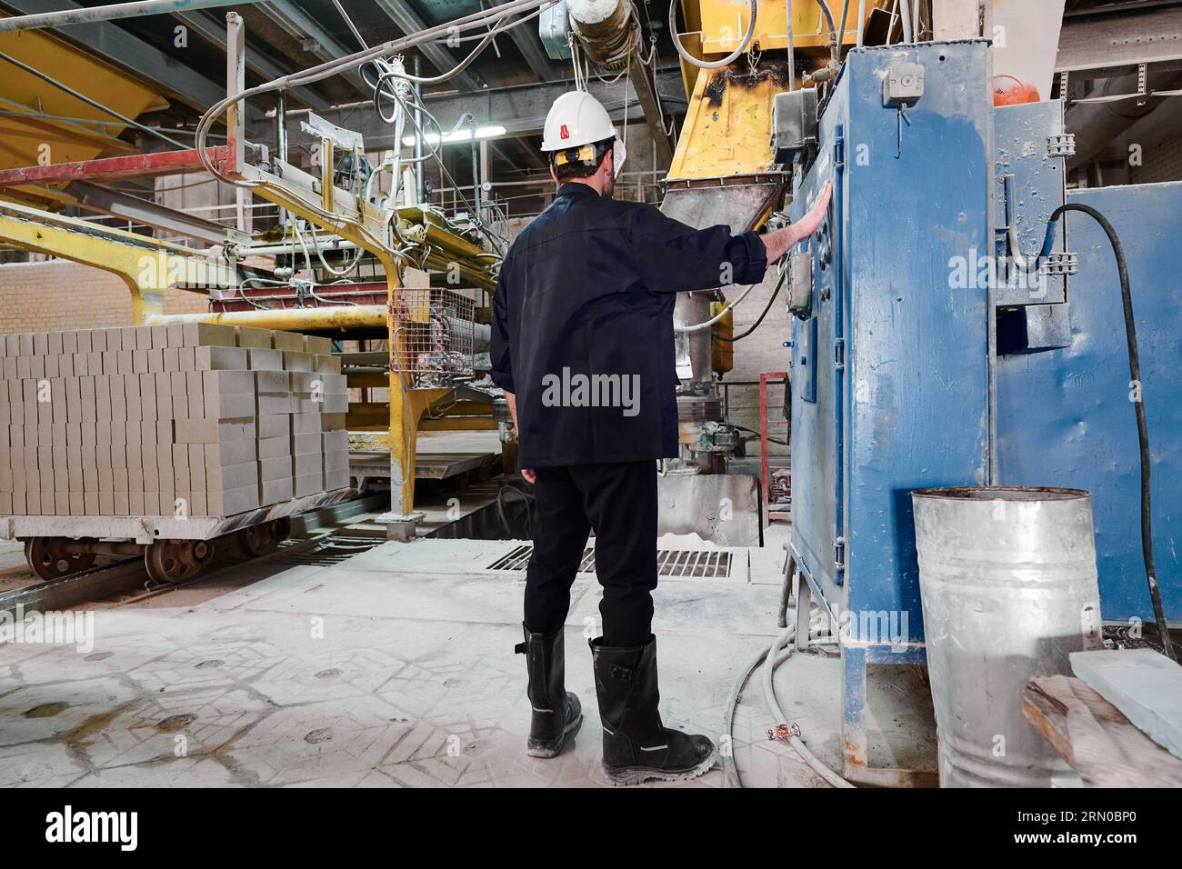 Worker controls process of concrete foam blocks production Stock Photo