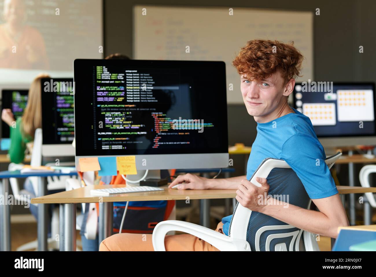 Portrait of student looking at camera while using computer at IT lesson Stock Photo