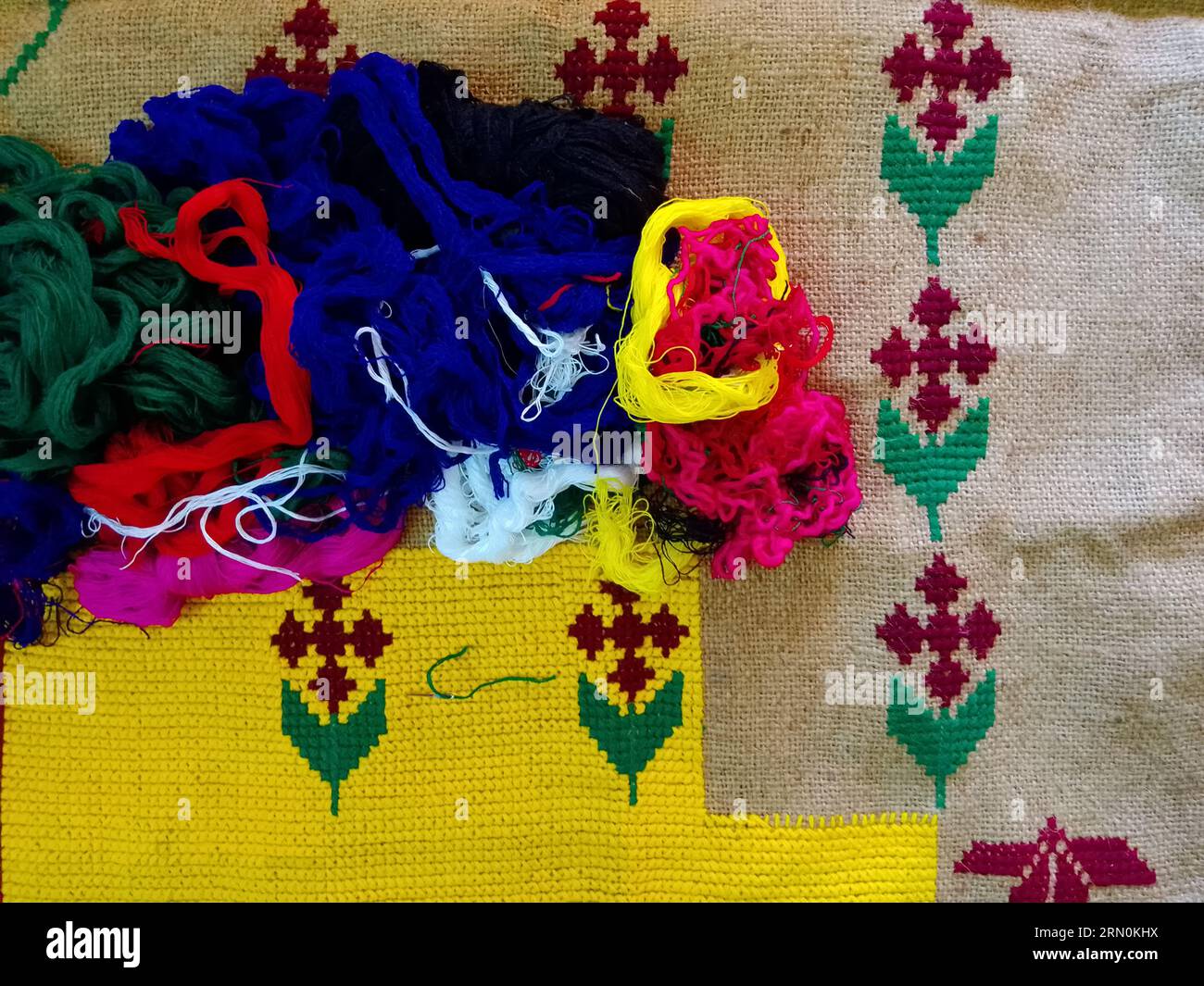 The colourful threads are on a cloth. Stock Photo