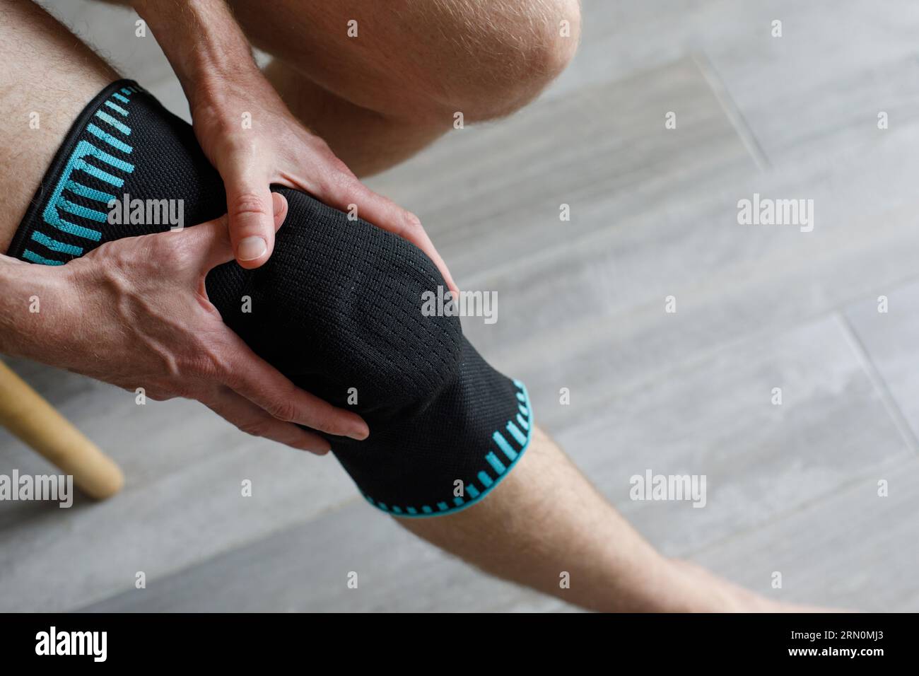 Closeup Knee Support Brace on male leg. Elastic orthopedic orthosis