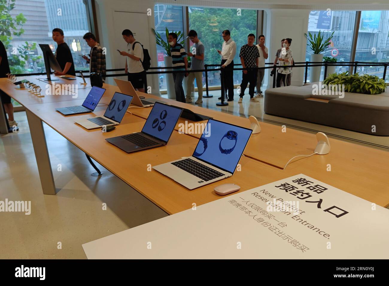 Fans line up at a Huawei store to try the Chinese brand's latest handset Mate 60 Pro in Shanghai, China Wednesday, Aug. 30, 2023. It marks Huawei's coming back with 5G chips after years of sanctions imposed by the U.S. (FeatureChina via AP Images) Stock Photo