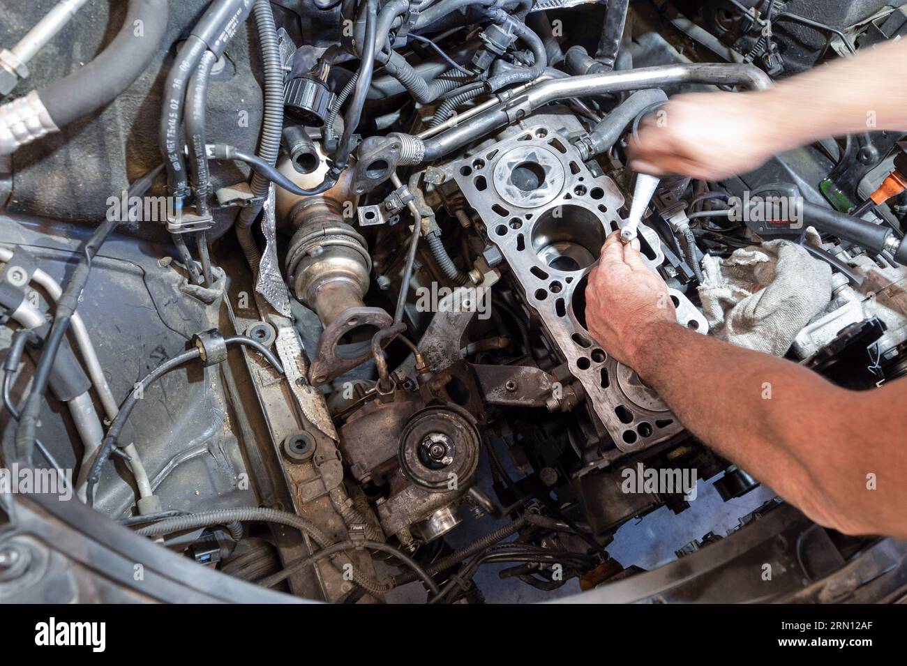 Mechanic working on an engine in a garage Stock Photo
